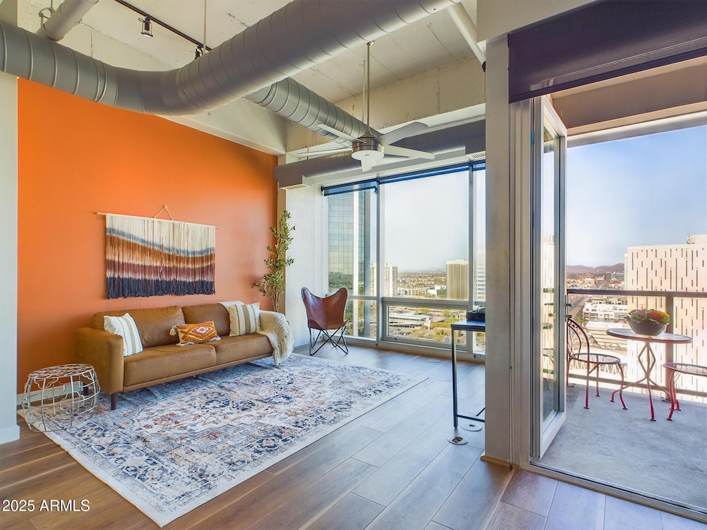 living room with hardwood / wood-style flooring, a wealth of natural light, floor to ceiling windows, and track lighting