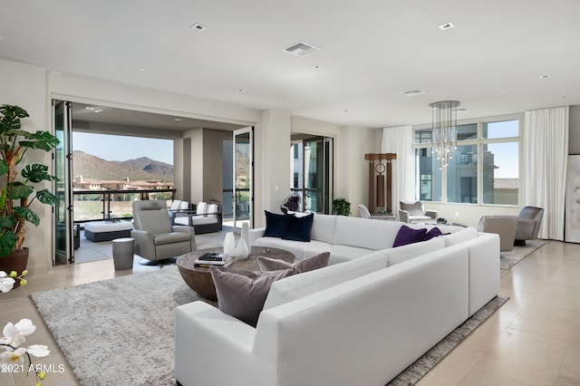 tiled living room with a chandelier and a mountain view