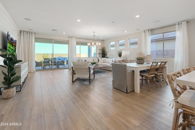 living room with a chandelier and light hardwood / wood-style floors