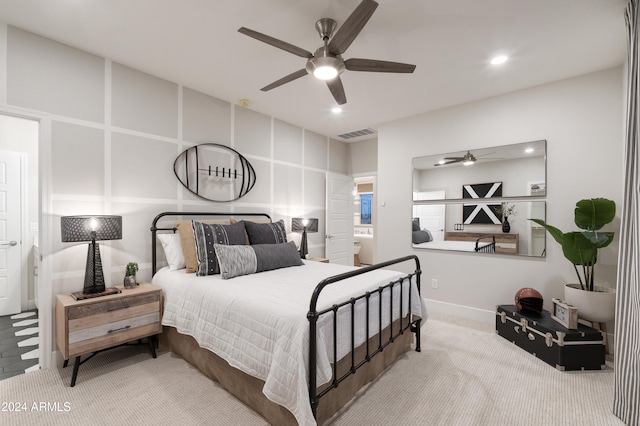 carpeted bedroom featuring ceiling fan and ensuite bathroom