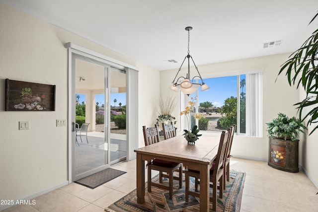 2163 N 164th Dr, Goodyear, AZ 85395 - dining area featuring light tile patterned floors, healthy amount of natural light, and a chandelier