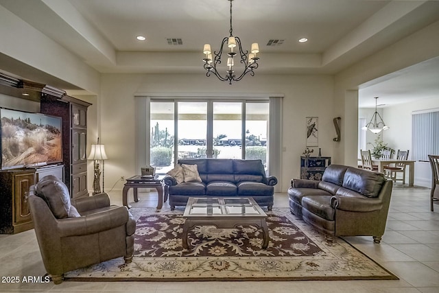 2163 N 164th Dr, Goodyear, AZ 85395 - tiled living area featuring a chandelier, a raised ceiling, and recessed lighting