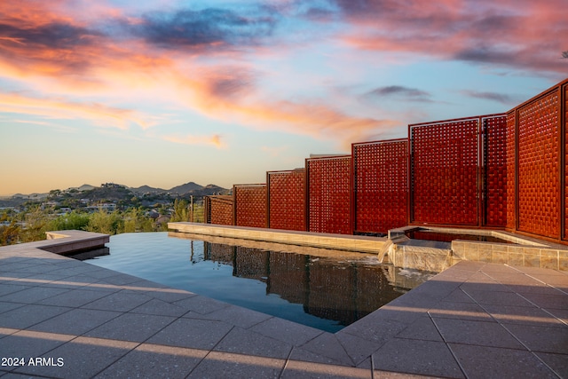 view of pool at dusk