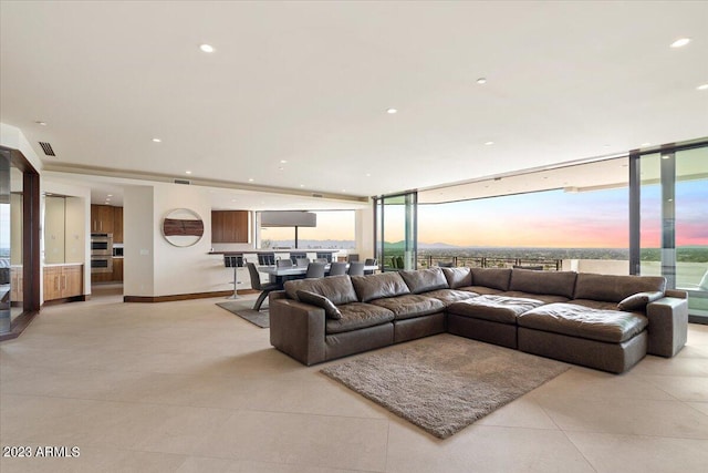 living room with floor to ceiling windows and a barn door