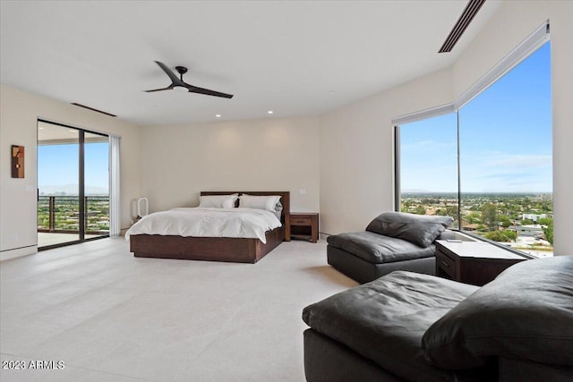 bedroom featuring multiple windows, access to exterior, and ceiling fan