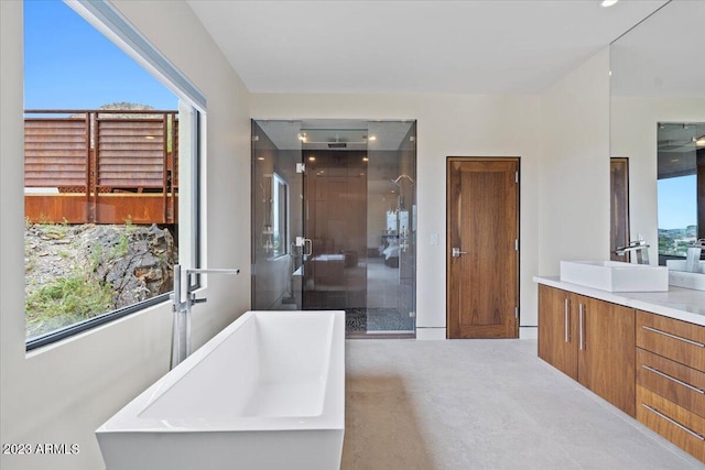 bathroom featuring a wealth of natural light, shower with separate bathtub, and vanity