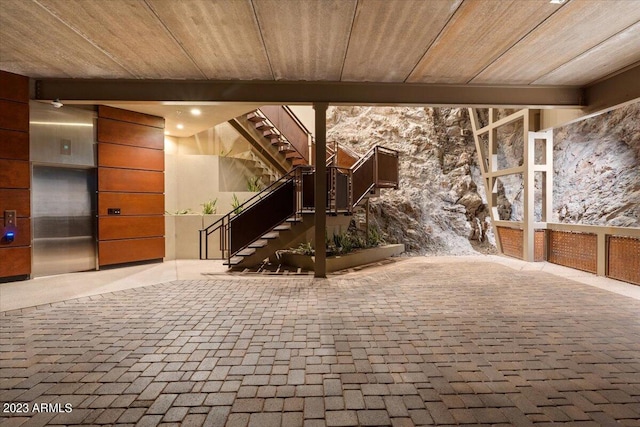 interior space featuring wood ceiling and elevator