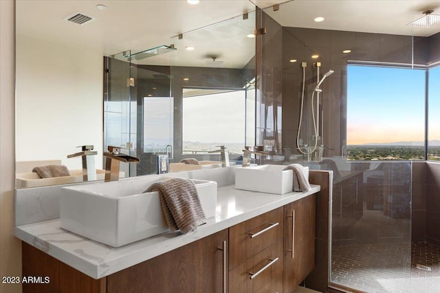 bathroom with vanity and a shower with shower door