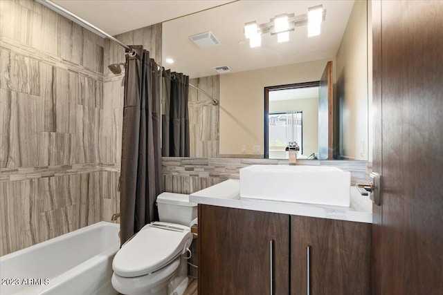 full bathroom featuring vanity, toilet, shower / tub combo, and tile walls