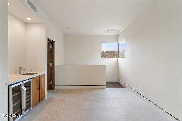 interior space featuring beverage cooler and sink