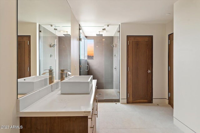 bathroom featuring a shower with shower door and vanity