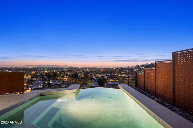 view of pool at dusk