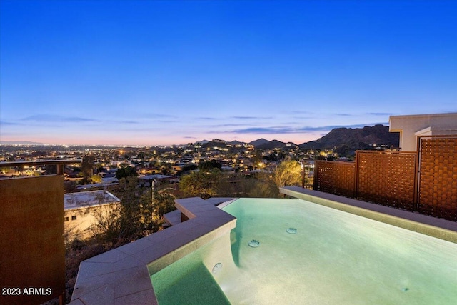 pool at dusk with a mountain view