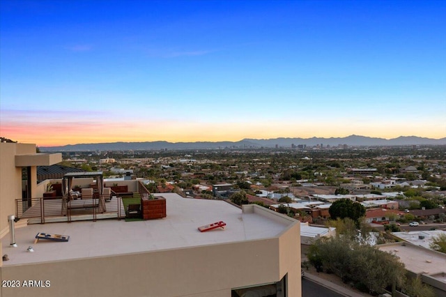 aerial view at dusk featuring a mountain view