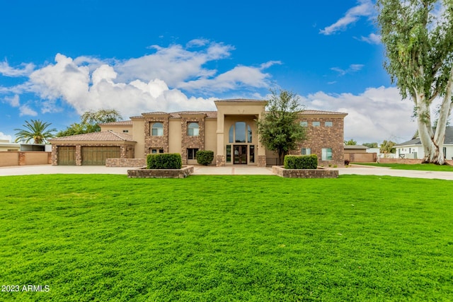 view of front facade featuring a garage and a front lawn