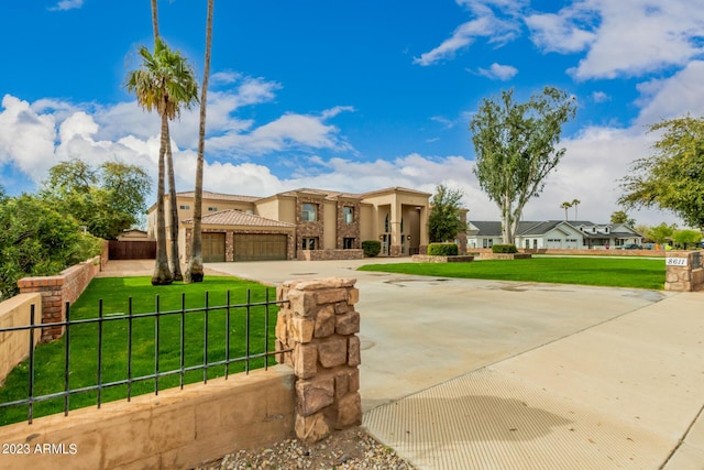 view of front of home with a front yard and a garage