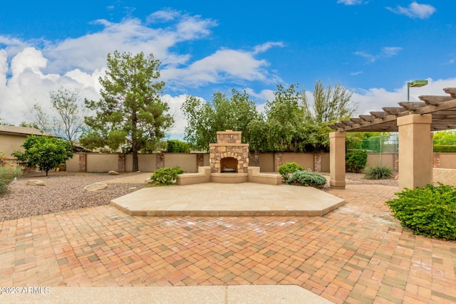 view of patio / terrace featuring an outdoor stone fireplace