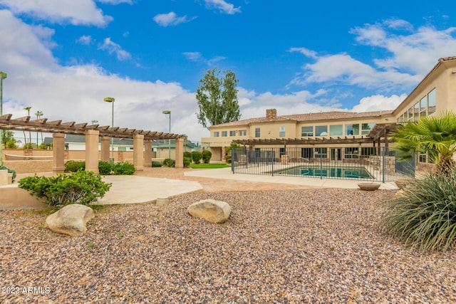 exterior space with a pool, a pergola, and a patio