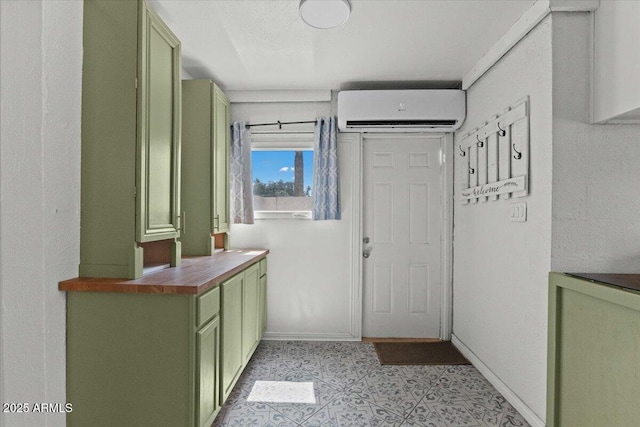 entryway featuring a wall unit AC and light tile patterned flooring