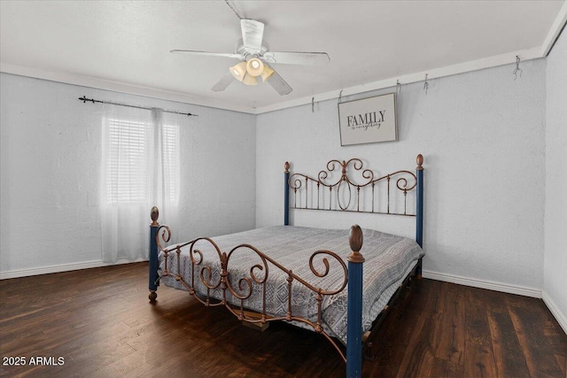 bedroom featuring baseboards, wood finished floors, a textured wall, and ceiling fan