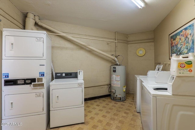 community laundry featuring water heater, stacked washer / dryer, washing machine and dryer, and light floors