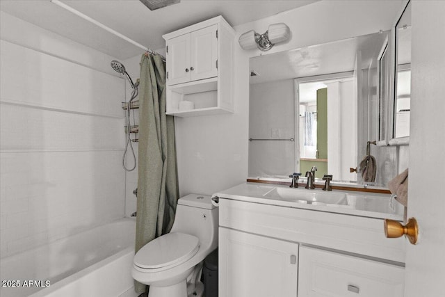 full bath featuring toilet, shower / bath combo with shower curtain, and vanity