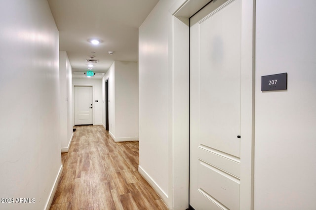 corridor featuring light hardwood / wood-style floors