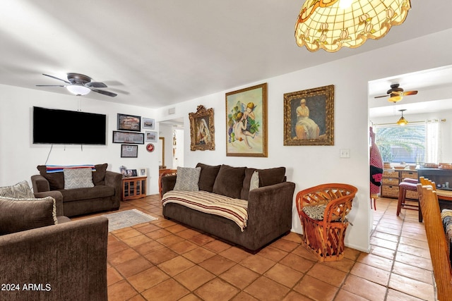 living area featuring light tile patterned floors, ceiling fan, and visible vents