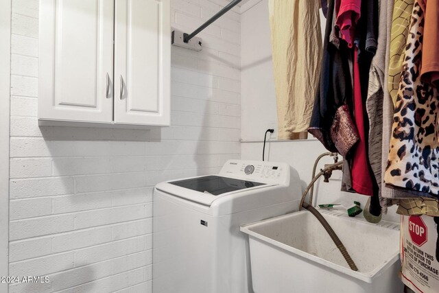 washroom with washer / clothes dryer and cabinets