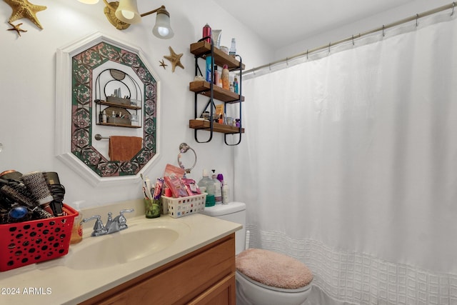 full bath featuring vanity and toilet