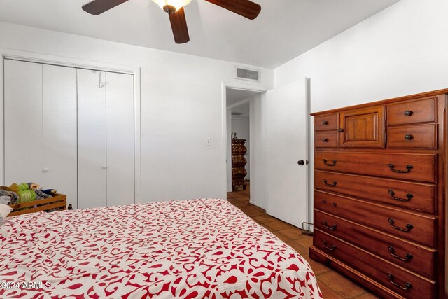 bedroom featuring a closet, ceiling fan, and light tile patterned flooring