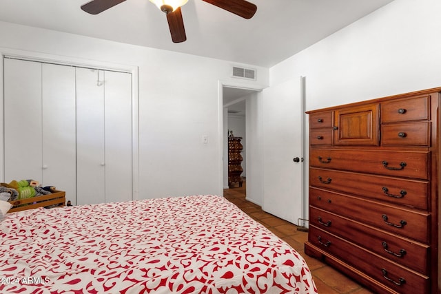 bedroom featuring a closet, visible vents, ceiling fan, and tile patterned floors