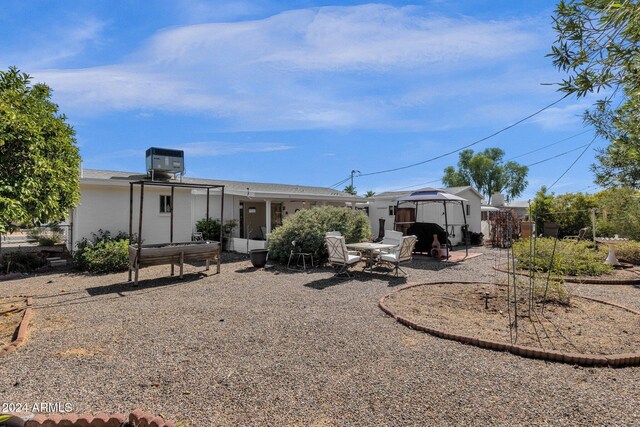 back of property featuring a shed