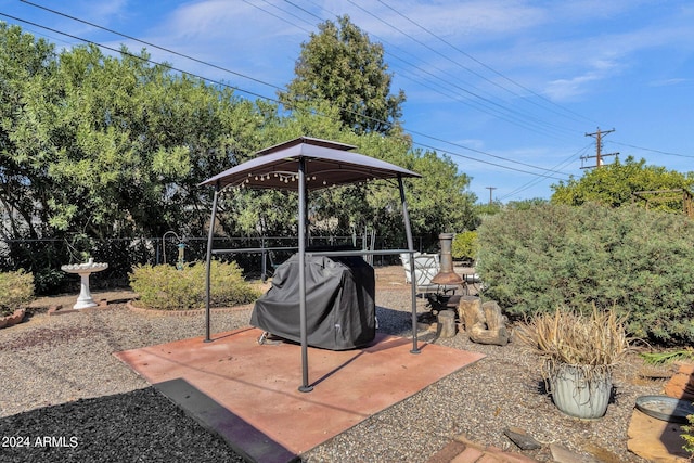 view of patio / terrace featuring a grill, fence, and a gazebo