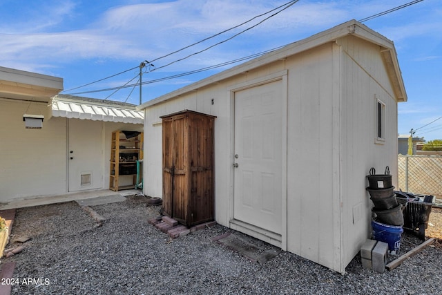 view of shed featuring fence