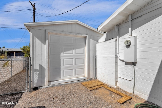 detached garage with fence and driveway