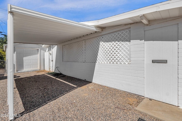 view of side of property featuring a carport, an outdoor structure, and a garage