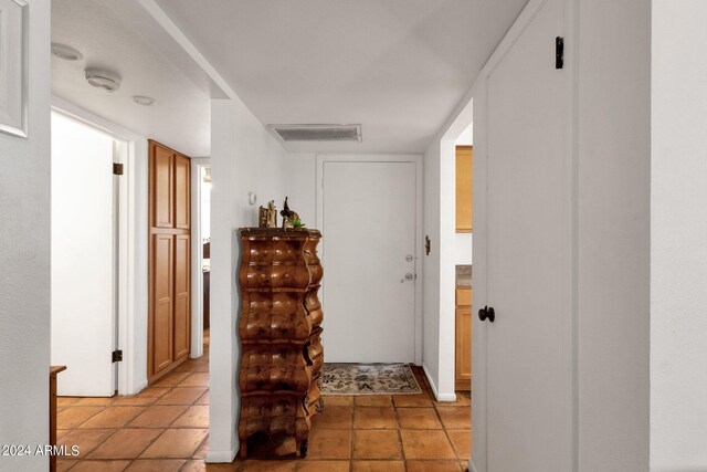 corridor with light tile patterned flooring