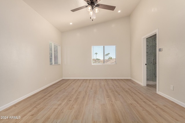 spare room featuring recessed lighting, light wood-style flooring, ceiling fan, high vaulted ceiling, and baseboards