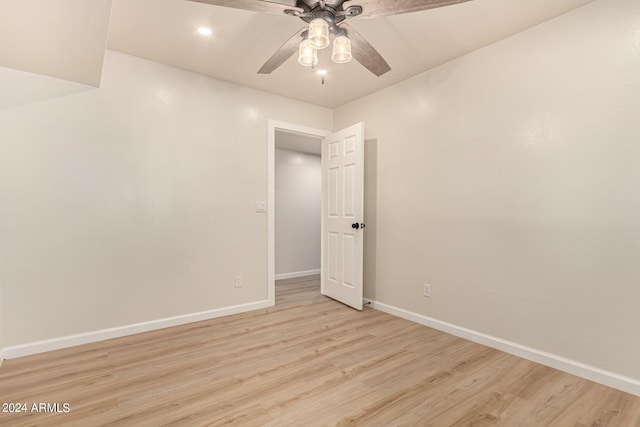 unfurnished room with baseboards, ceiling fan, and light wood finished floors