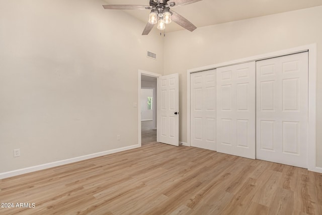 unfurnished bedroom with baseboards, visible vents, ceiling fan, light wood-style floors, and a closet