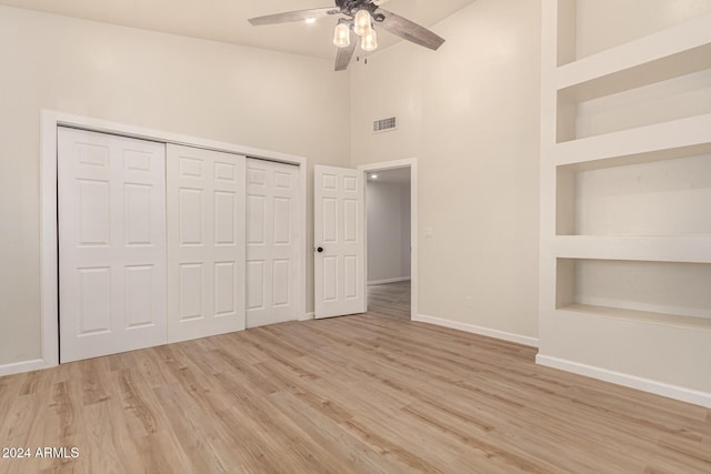 unfurnished bedroom with light wood finished floors, a closet, visible vents, a ceiling fan, and baseboards