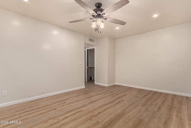 empty room featuring visible vents, ceiling fan, light wood-style flooring, and baseboards