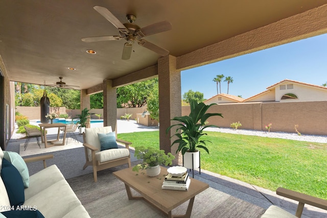 view of patio / terrace with a fenced in pool, a fenced backyard, and a ceiling fan