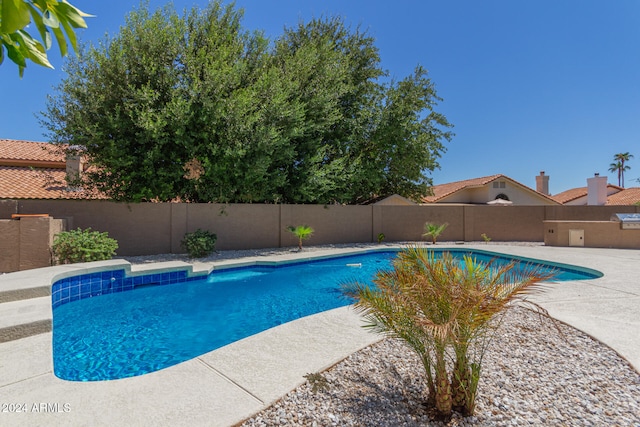 view of swimming pool featuring a patio area, a fenced backyard, and a fenced in pool