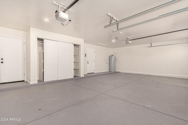 garage with water heater and a garage door opener