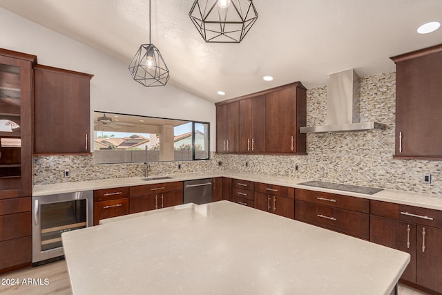 kitchen featuring wine cooler, black electric cooktop, hanging light fixtures, light countertops, and wall chimney exhaust hood