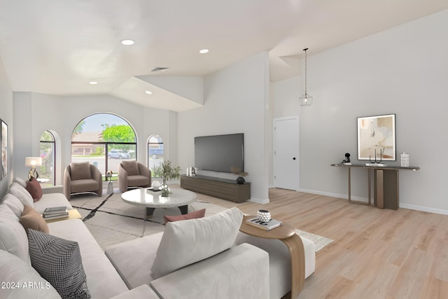 living room with recessed lighting, visible vents, light wood-style flooring, high vaulted ceiling, and baseboards