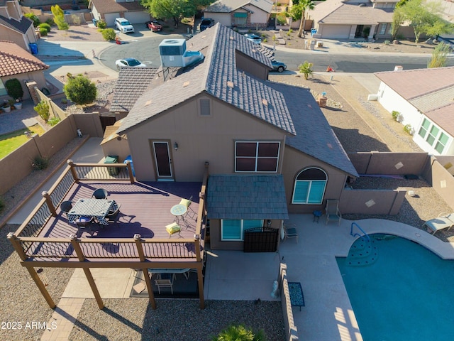 4547 E Buist Ave, Phoenix, AZ 85044 - back of house featuring a residential view, a fenced backyard, a deck, stucco siding, and a shingled roof