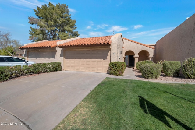 mediterranean / spanish-style home with a tile roof, driveway, an attached garage, and stucco siding